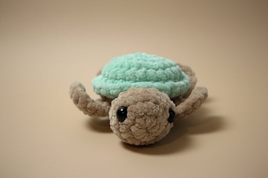 Handmade crochet mini turtle plushie from the amigurumi marine life collection of the baseline handicraft, crafted in France with love.