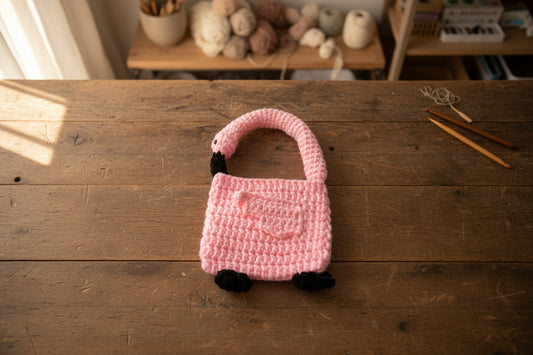 Handmade crochet flamingo hand bag from the wearables bag collection of the baseline handicraft, crafted in France with love. 