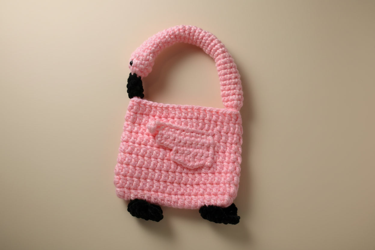 Handmade crochet flamingo hand bag from the wearables bag collection of the baseline handicraft, crafted in France with love. 