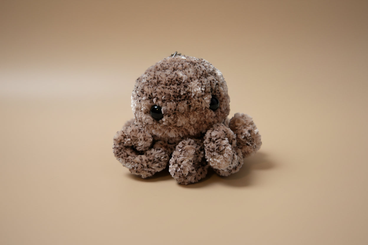 Handmade crochet keychain mini octopus from the amigurumi marine life collection of the baseline handicraft, crafted in France with love. 
