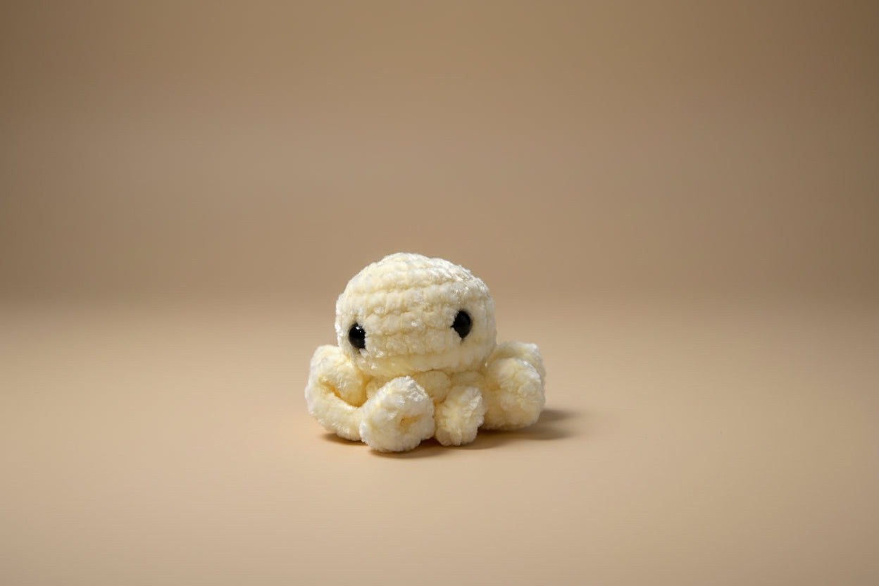 Handmade crochet mini octopus desk charm from the amigurumi marine life collection of the baseline handicraft, crafted in France with love. 