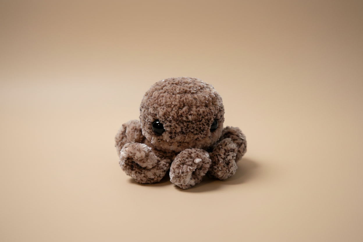 Handmade crochet mini octopus desk charm from the amigurumi marine life collection of the baseline handicraft, crafted in France with love. 