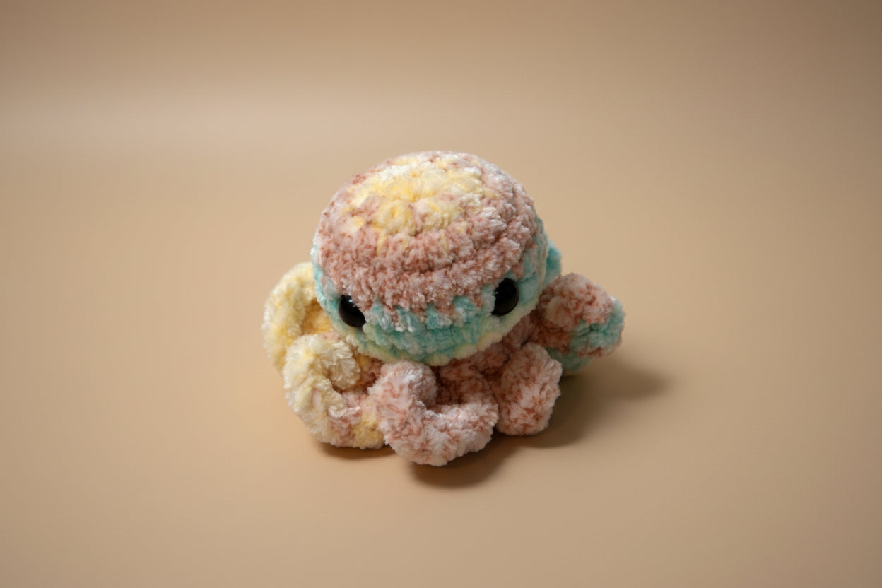 Handmade crochet mini octopus desk charm from the amigurumi marine life collection of the baseline handicraft, crafted in France with love. 