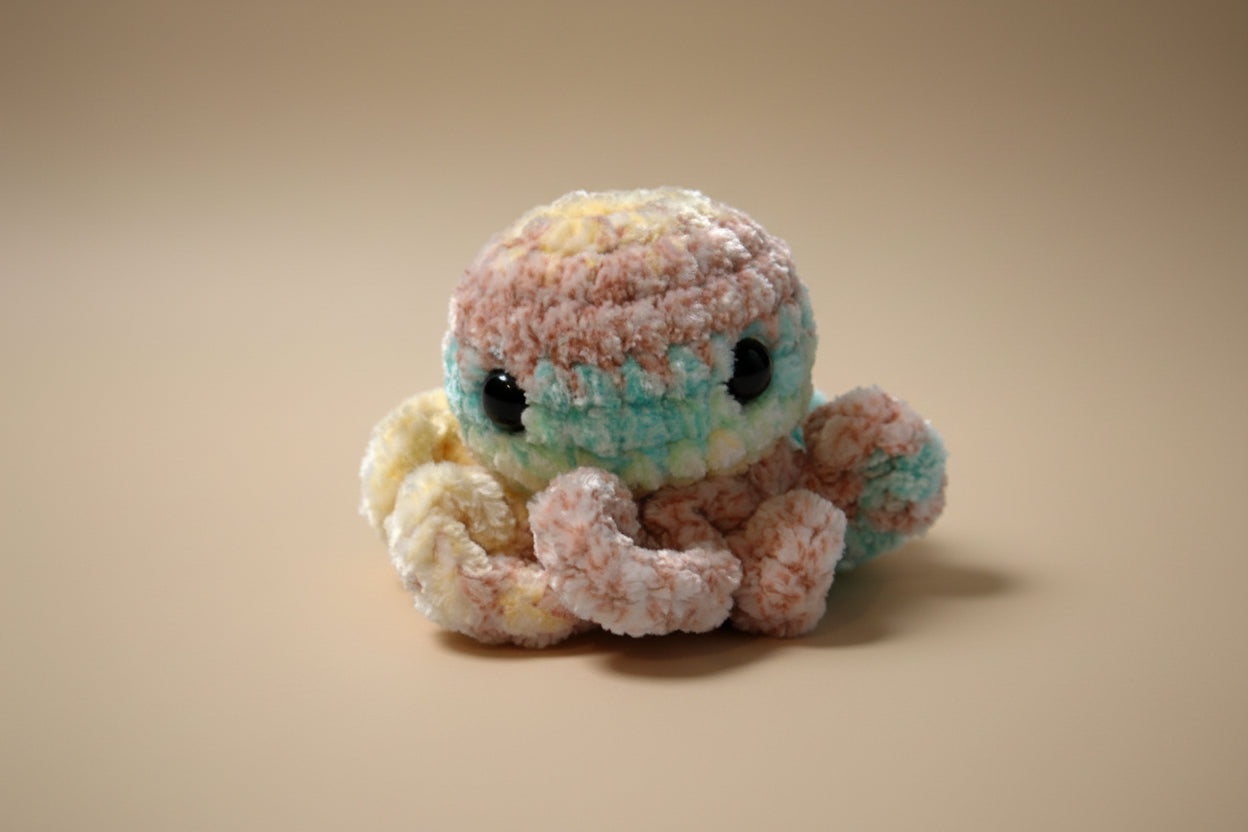 Handmade crochet mini octopus desk charm from the amigurumi marine life collection of the baseline handicraft, crafted in France with love. 