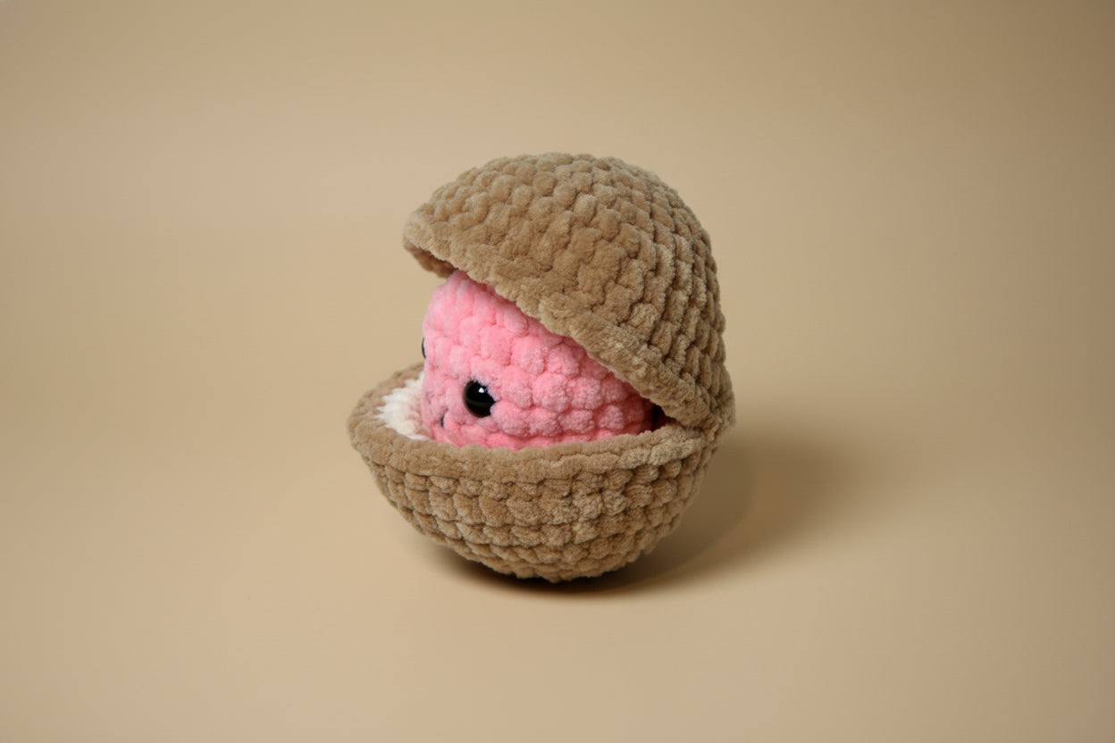 Handmade crochet pearl clam plush from the marine life collection of the baseline handicraft, crafted in France. 