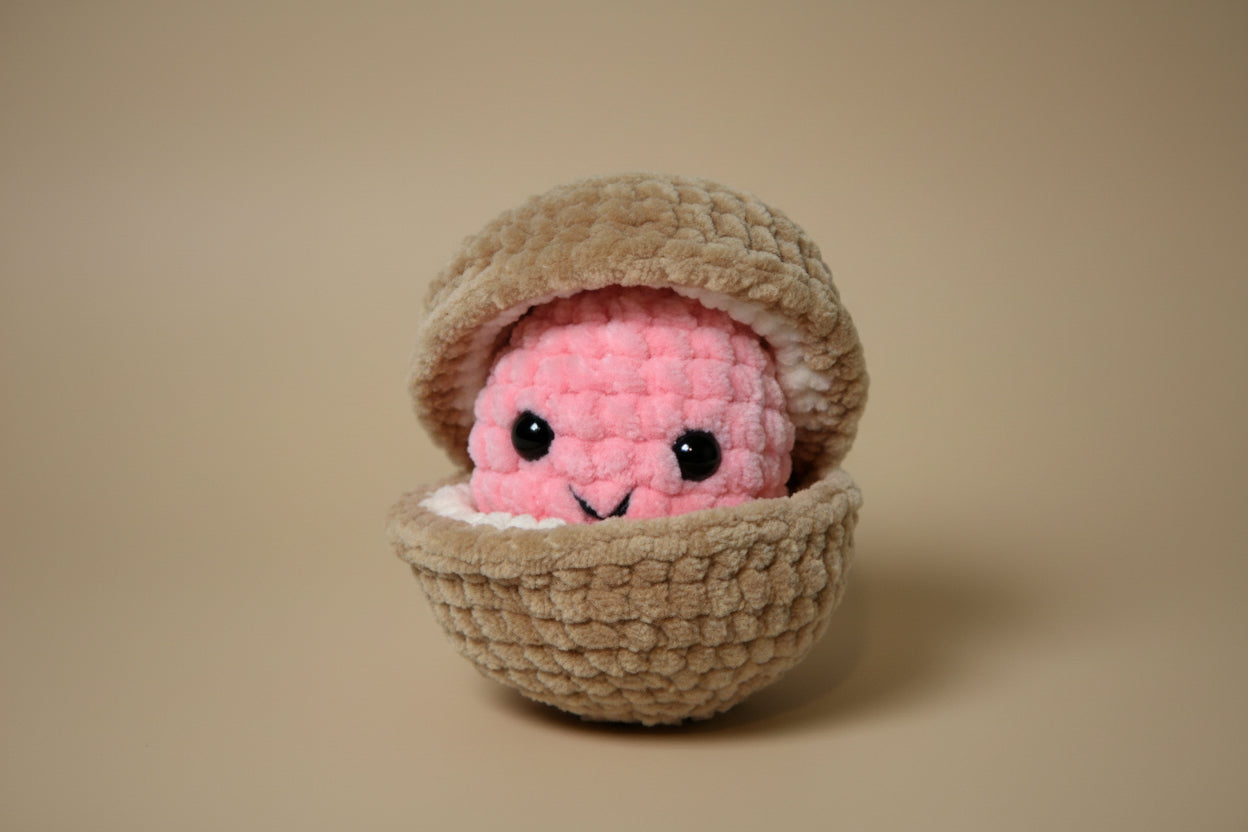 Handmade crochet pearl clam plush from the marine life collection of the baseline handicraft, crafted in France. 